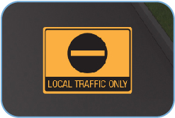 A sign discouraging cut through traffic along a local road