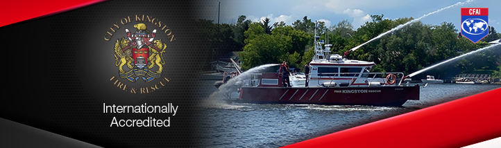 A Kingston Fire and Rescue boat sprays water on a clear day. A black and red graphic partially overlays the image with the Kingston Fire and Rescue logo and text that says, “Internationally Accredited.”